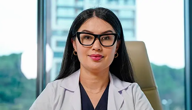 Dr. Gulchehra Alam sitzt im Stuhl an einem Tisch in der Elit Klinik