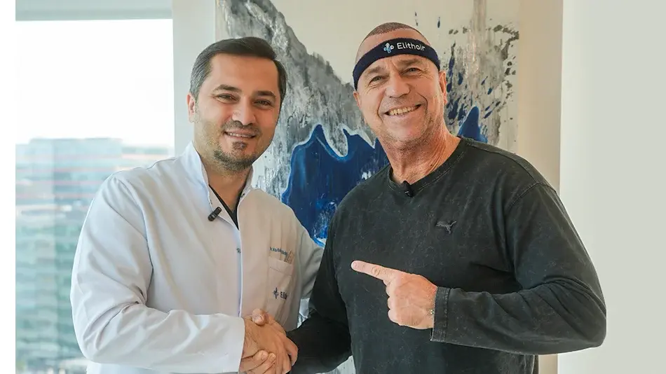 Bild zeigt wie Kai Ebel und Dr. Abdulaziz Balwi sich nach der Haartransplantation die Hand geben und in die Kamera lächeln